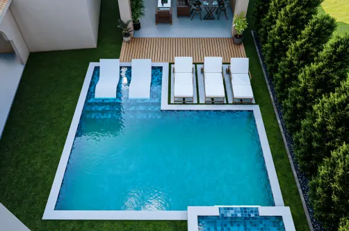 Detailed application of premium blue glass tiles and high-durability plaster finish for a modern pool remodel.