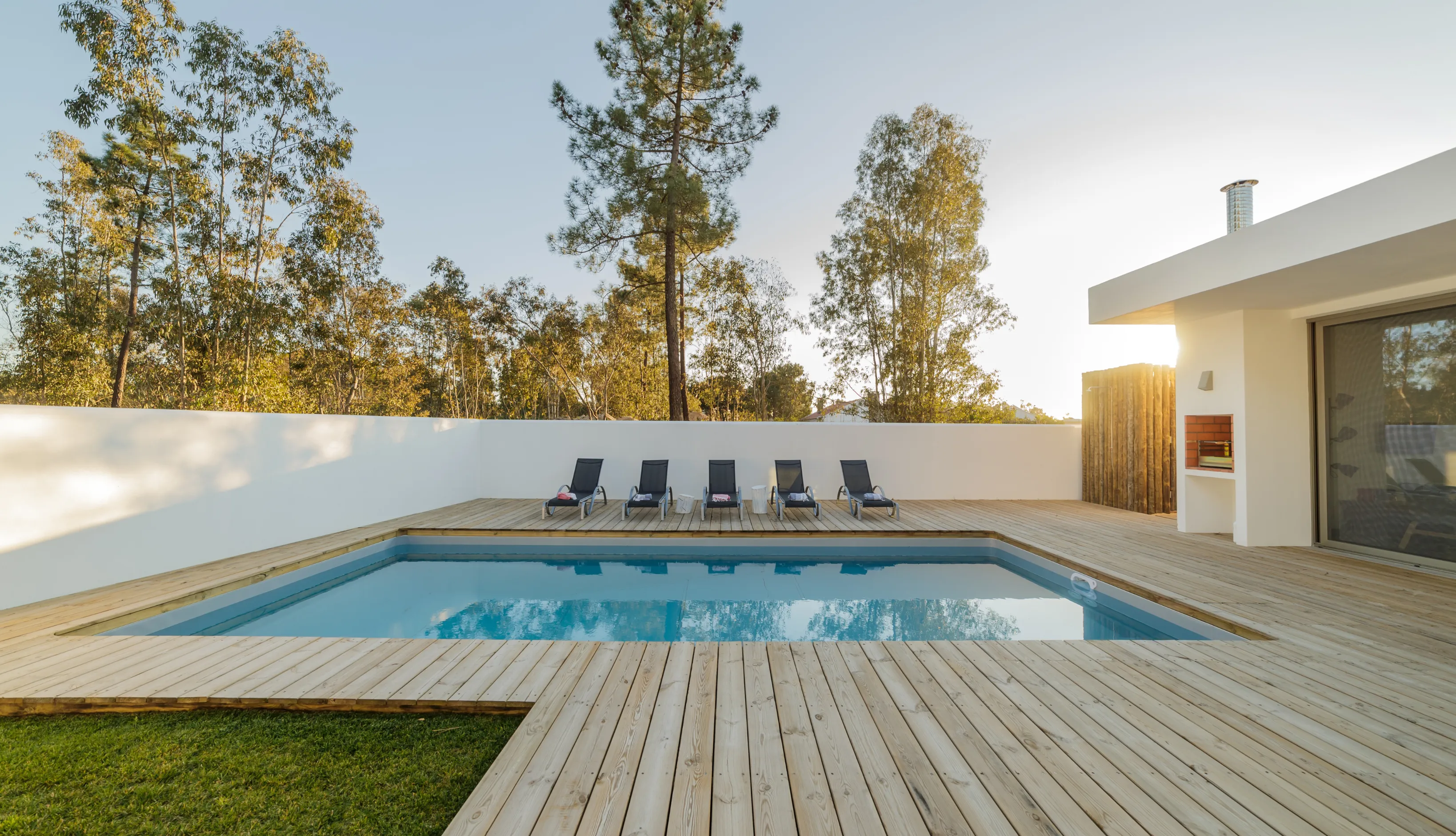 Contemporary blue tile lap pool design optimized for narrow backyard spaces in Southern California luxury homes