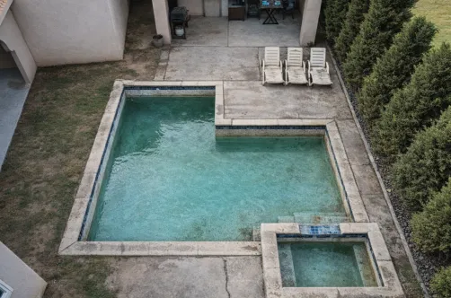 Initial structural phase of a professional pool remodel in Los Angeles, showing reinforced walls and ground preparation.