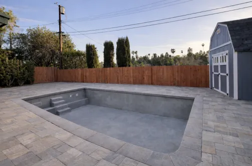 Professional pool contractor installing high-efficiency plumbing lines and filtration equipment for a smart pool system.