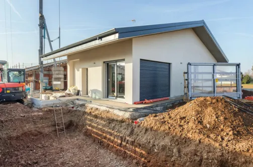 New custom pool with premium blue tile finish being filled for the first time after successful construction.