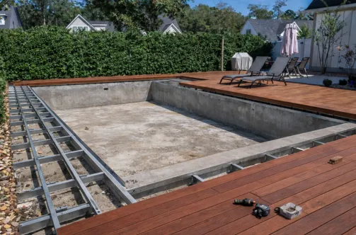 Professional pool contractor installing high-efficiency plumbing lines and filtration equipment for a smart pool system.