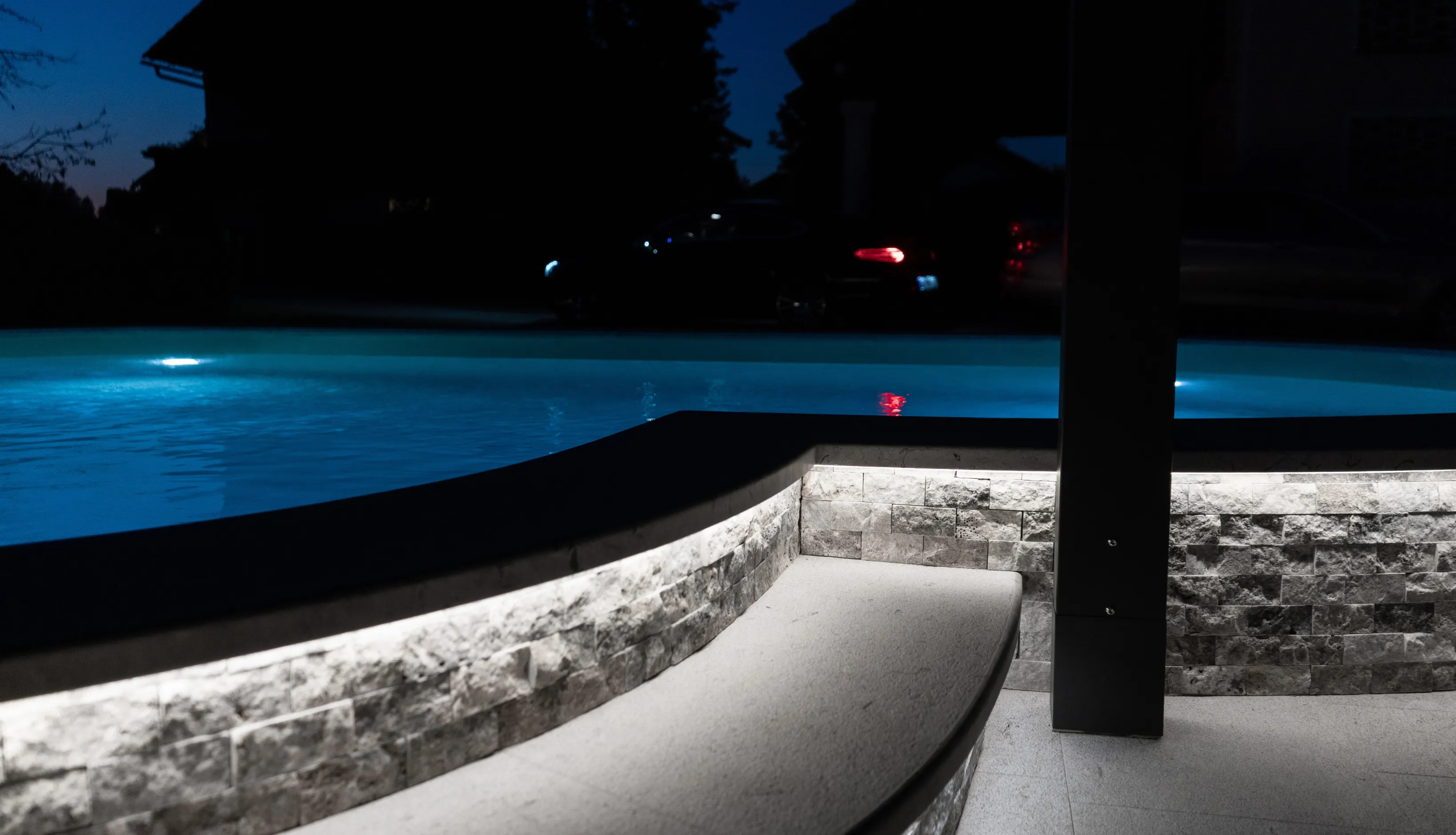 Modern rectangular swimming pool with premium wood decking and integrated lounge area in a Los Angeles backyard.