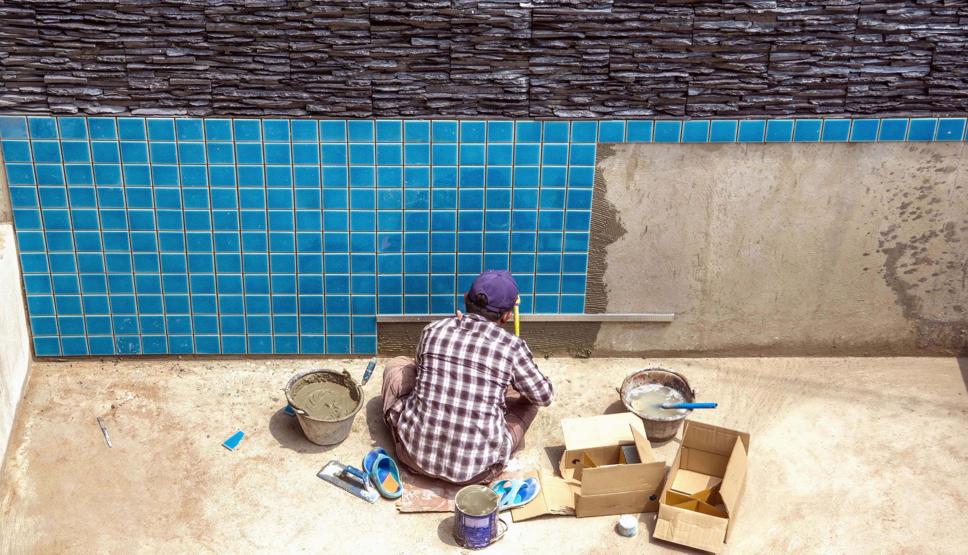 Modern rectangular swimming pool with premium wood decking and integrated lounge area in a Los Angeles backyard.